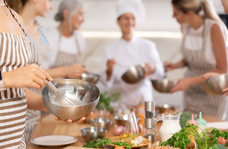 Young woman In Apron Learning To Cook
